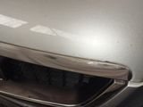 a close up of a car ' s front bumper with a sticker on it