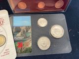 some coins are sitting on top of a table next to a book