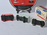 three toy trains sitting next to each other on a table