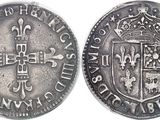 a close up of a coin with a cross on it