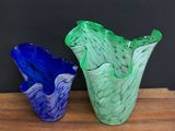 two vases that are sitting on a wooden table
