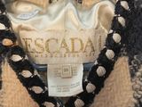 a close up of a black and white sweater on a hanger
