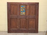 a wooden door with a blue and gold design on it