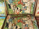 four pieces of vintage children ' s board games in a wooden box