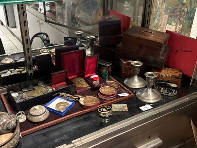 a display case with a lot of antique items on it