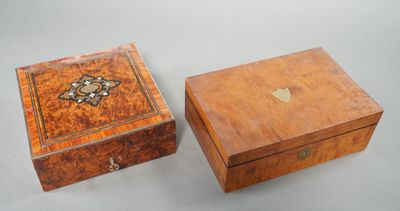 two wooden boxes with decorative designs on them sitting on a table