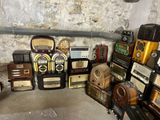 many old radio ' s sitting on the floor in a room