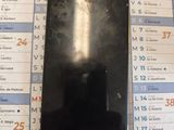 a black cell phone sitting on top of a calendar
