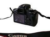 a canon camera with a strap attached to it
