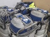 several vacuums are lined up in a room next to a wall