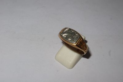 an image of a gold ring with a roman numeral on it