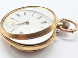 a gold pocket watch with roman numerals on it