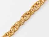 a close up of a gold bracelet on a white surface