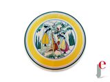 a yellow plate with a picture of a woman and a bird on it