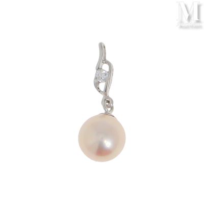 un gros plan d'un pendentif en perle et diamant sur fond blanc