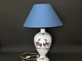a white lamp with a blue shade on it