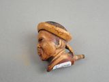 a small figurine of a man with a hat on his head