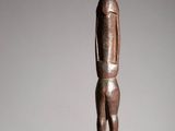 an old wooden statue of a man standing on a pedestal