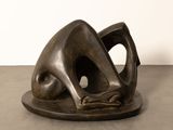 bronze sculpture of a woman ' s head on a plate on a table