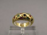 a close up of a gold ring with multi colored stones on it