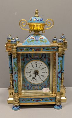 a blue and gold clock sitting on a table
