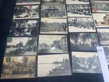 a lot of old black and white pictures on the table