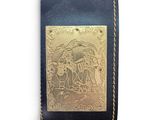 leather wallet with gold plated design on it on a white background