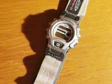 a close up of a watch on a wooden table