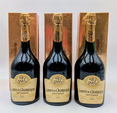trois bouteilles de champagne devant un coffret doré