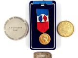 a medal and a coin sitting next to each other on a table