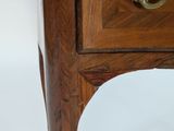 a small wooden table with a drawer on top of it