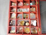 a red box with many different types of perfumes in it