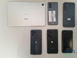 several cell phones are lined up next to each other on a table