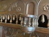 a fireplace mantle with a bunch of bells on top of it