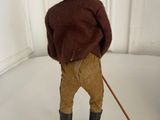 a figurine of a man wearing a hat and holding a cane