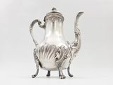 a silver tea pot on a stand on a white background
