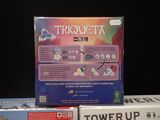a box of triquetta next to a box of tower up