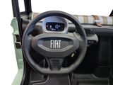 steering wheel and dashboard of a small car with a clock on the dash