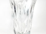 a glass vase that is sitting on a white surface