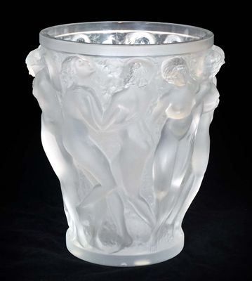 a glass vase with a design on it on a black background