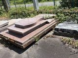 a pile of concrete blocks on the ground next to a fence