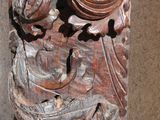 a close up of a wooden carving on a wall