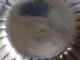 a silver plate with a cross on it sitting on a table