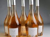 four bottles of wine are lined up on a table