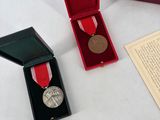 a small box with a medal and a medal in it