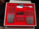 a red box with silverware in it on a table