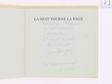 an open book with writing on it on a white surface