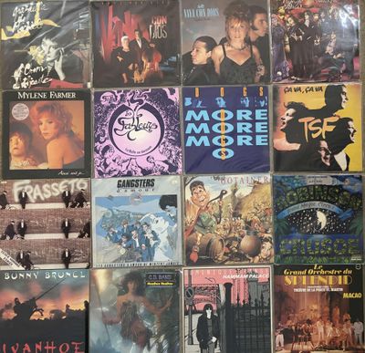 many different album covers on the wall of a room