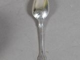 a silver spoon with a spoon handle on a table