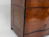 an old wooden box with a drawer on top of it